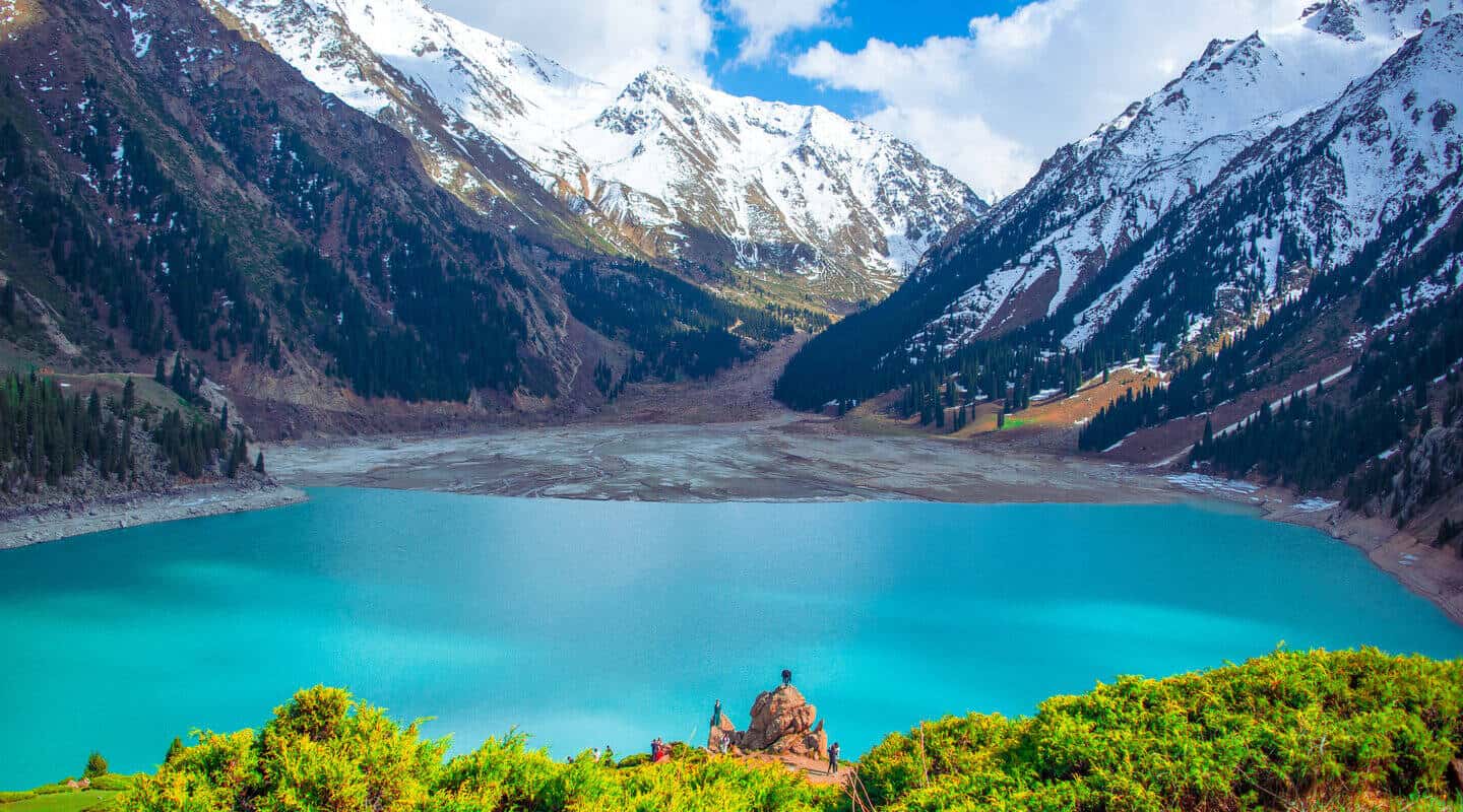 Turquoise waters of Big Almaty Lake surrounded by mountains