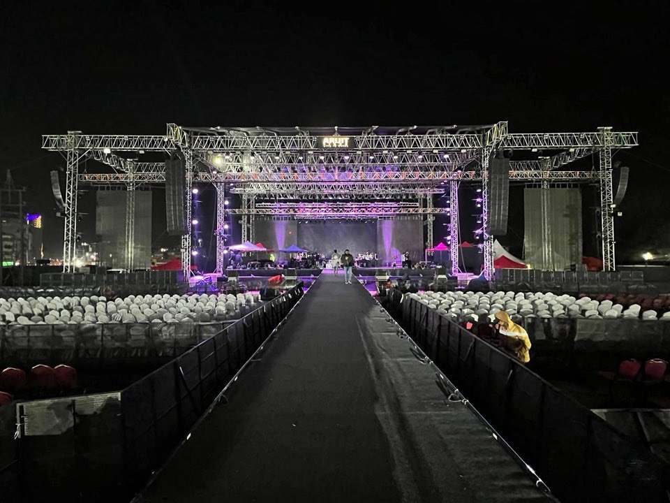 Elaborate concert stage setup with lights and screens