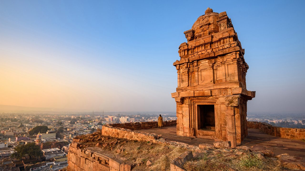 Badami Caves carved into red sandstone cliffs