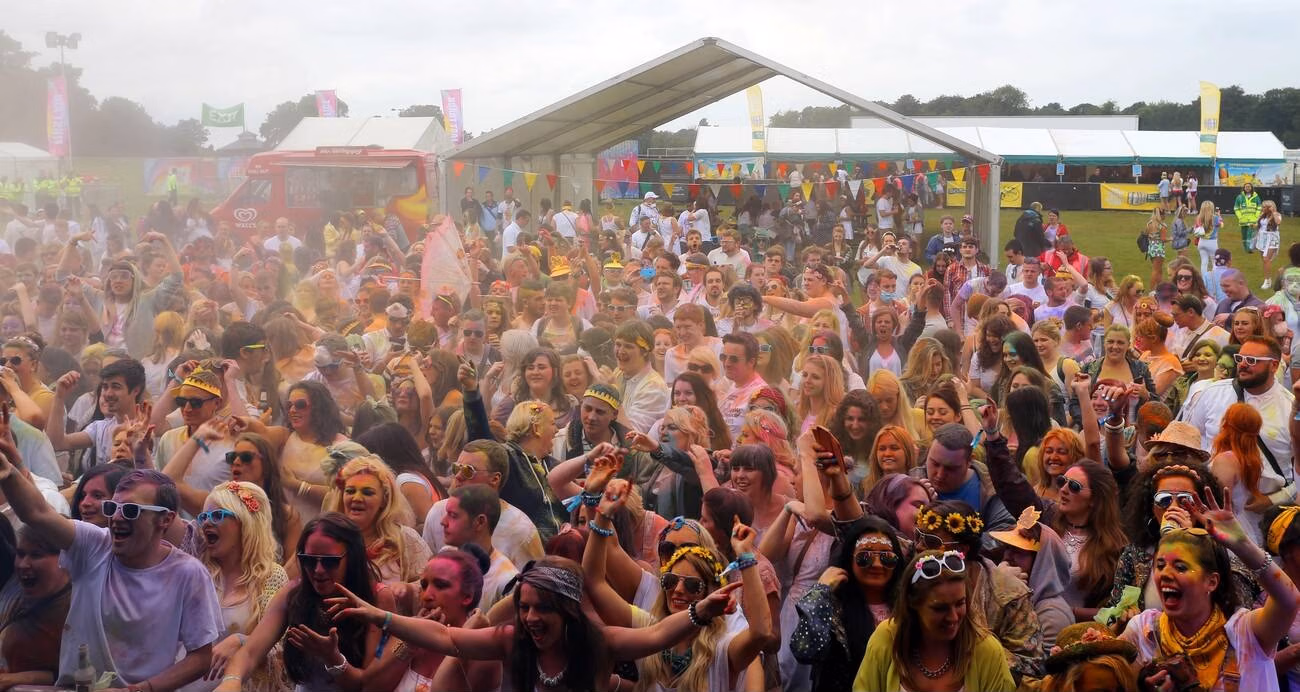Holi celebration crowd and color festival vibe in Noida