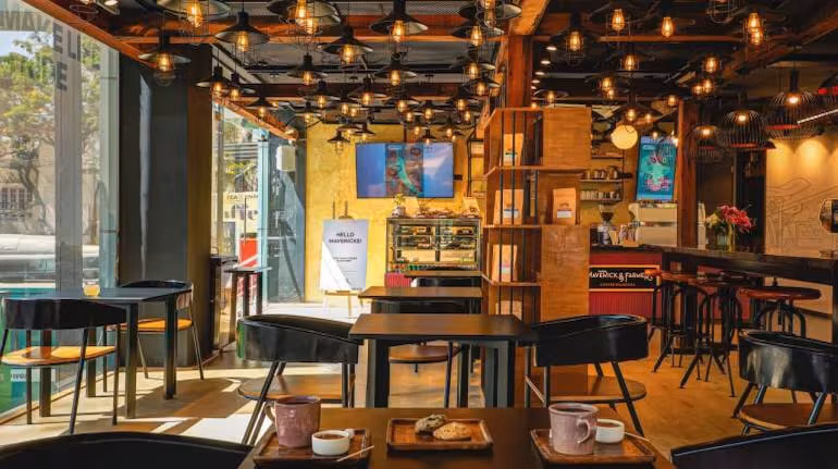 Students studying with laptops at cafe in Kolar