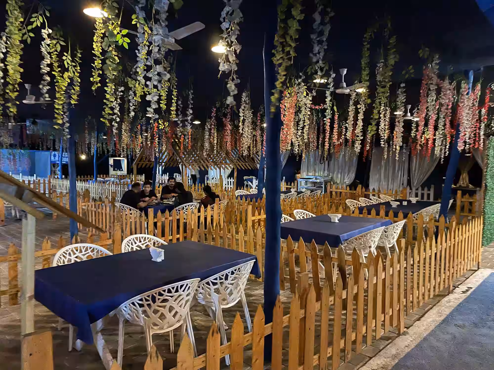 Scenic garden cafe in Silvassa with outdoor seating amidst lush greenery