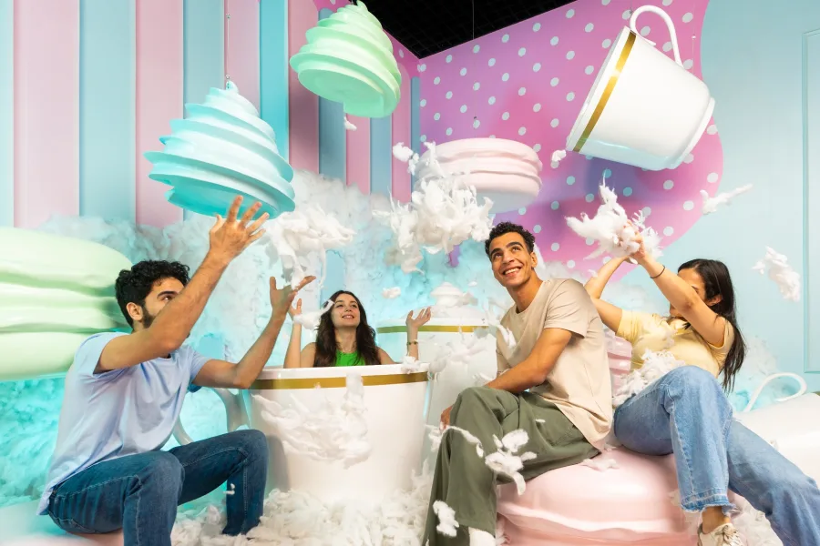 Happy family taking photos together at Candy Museum Dubai