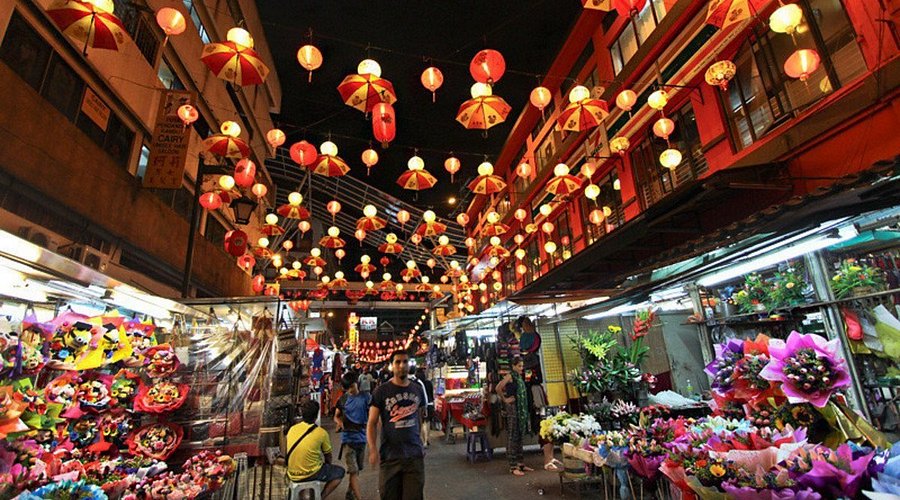 Petaling Street market in Chinatown Kuala Lumpur with vibrant stalls and shoppers