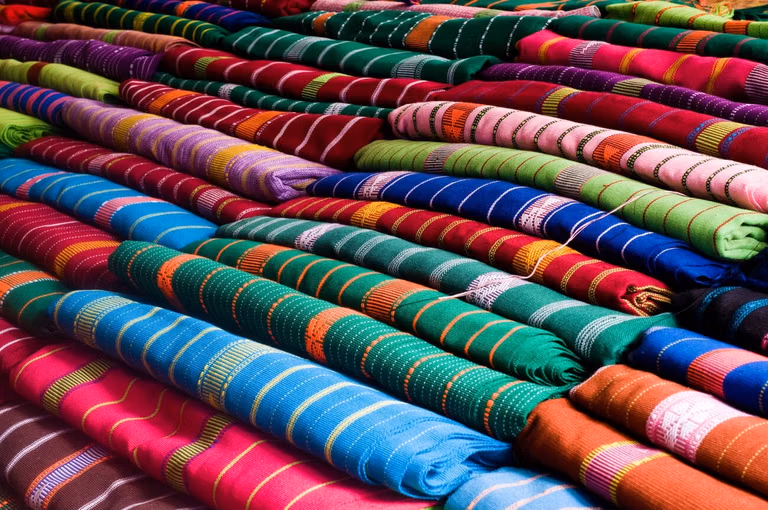 Colorful fabric stacks in Ambala textile market