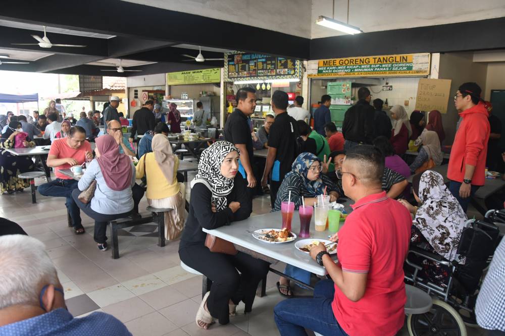 Multi-ethnic dining table representing Malaysian cuisine diversity