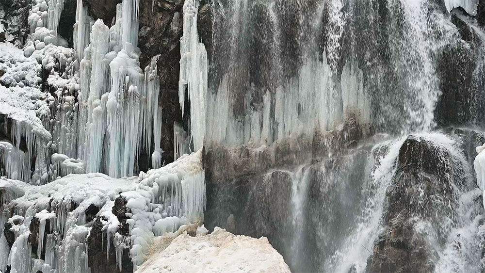 Drung Waterfall cascading through a rocky valley in Kashmir