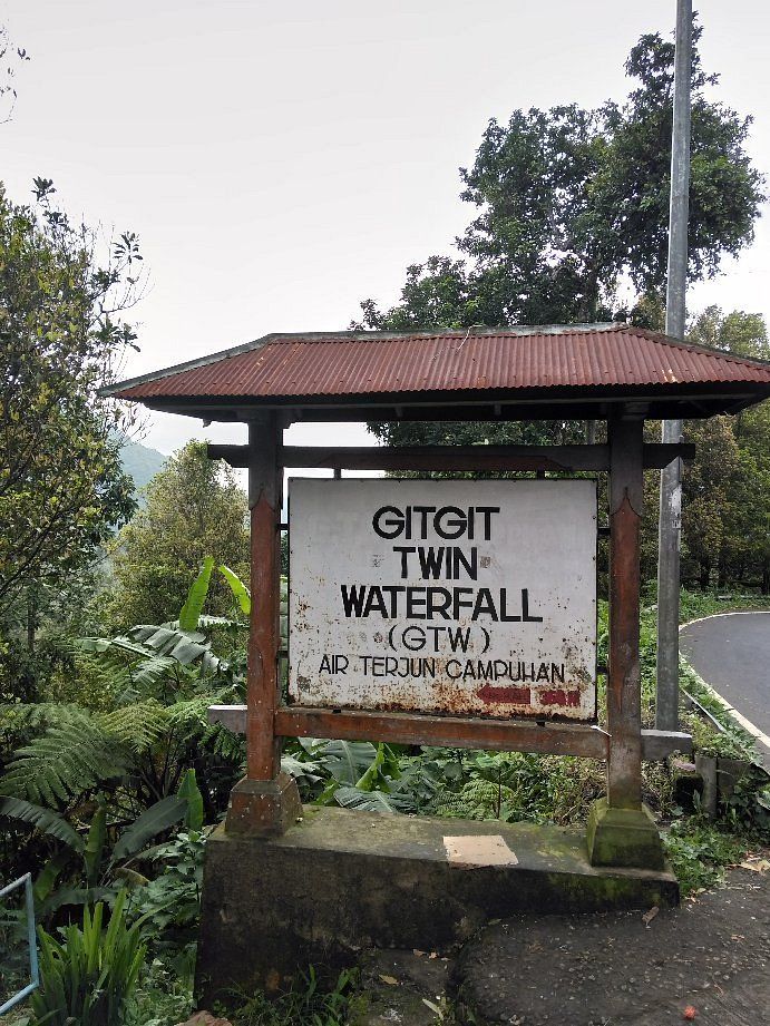 Scenic mountain road to Gitgit Waterfall through Balinese countryside