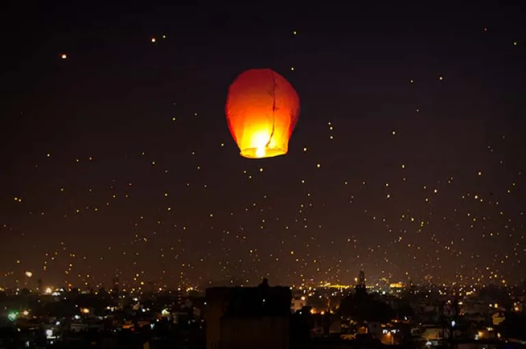 Night kite flying and illuminated tukkal atmosphere in Ahmedabad