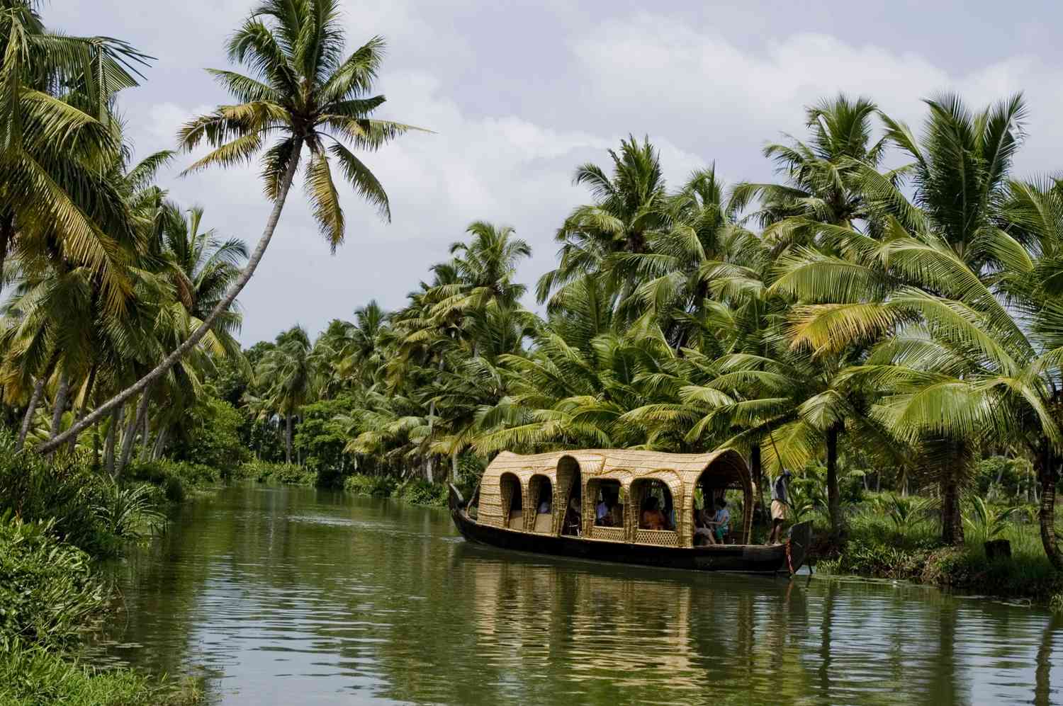 Traditional Kerala houseboat on backwaters at sunset