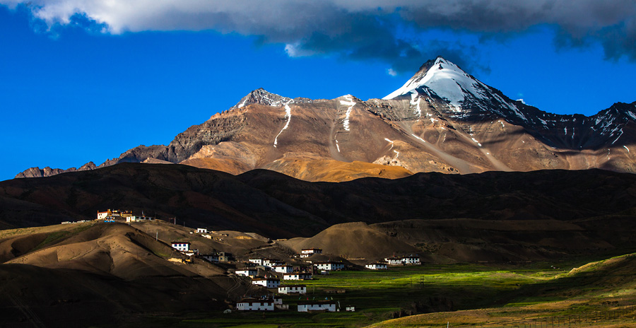Langza village in Spiti Valley with mountains and prayer flags