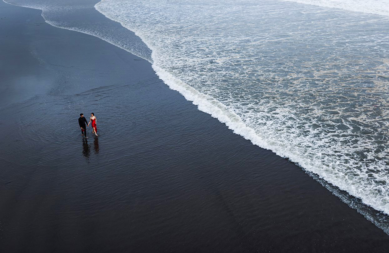 Lovina black sand shoreline with calm sea in North Bali