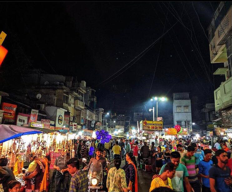 Night market seating and food counters at Manek Chowk