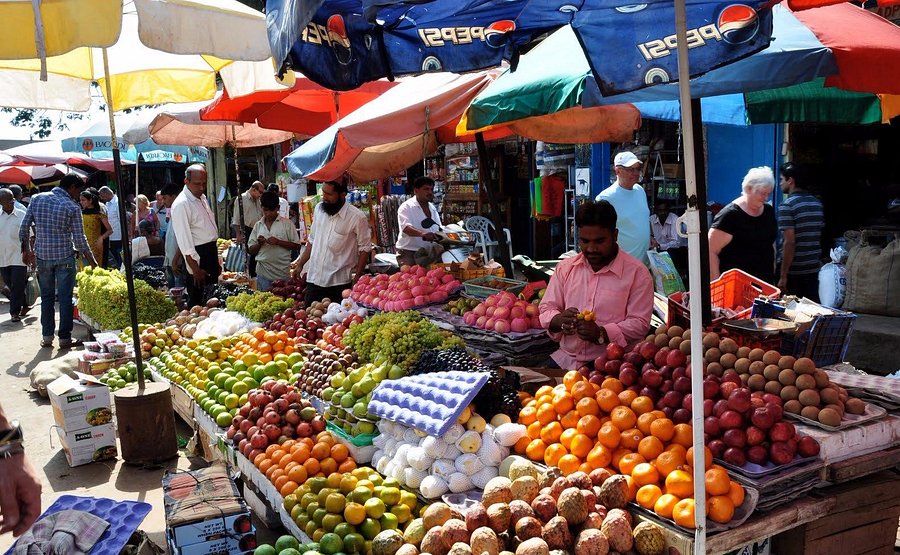 Busy Mapusa Friday Market lanes with colorful stalls in Goa