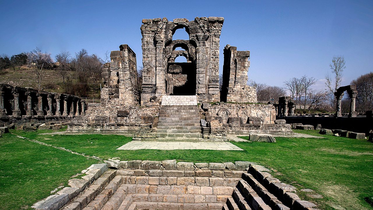 Martand Sun Temple ruins in Kashmir with mountain backdrop