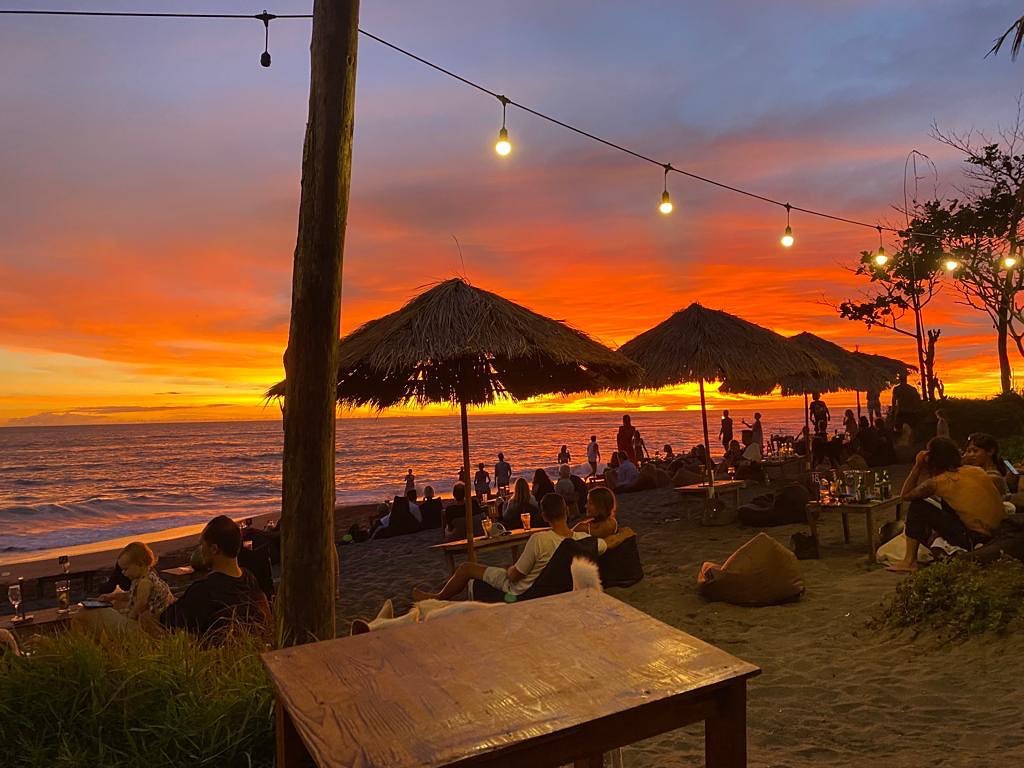Bali nightlife with beach club lights and evening crowd