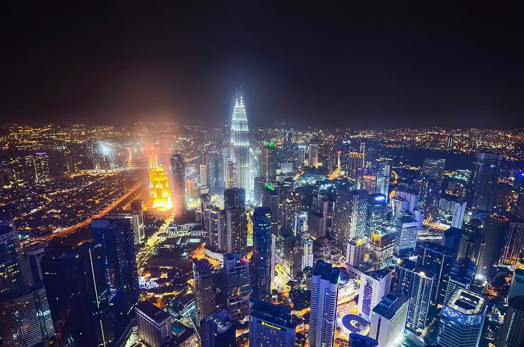 Kuala Lumpur skyline at night with bars and city lights