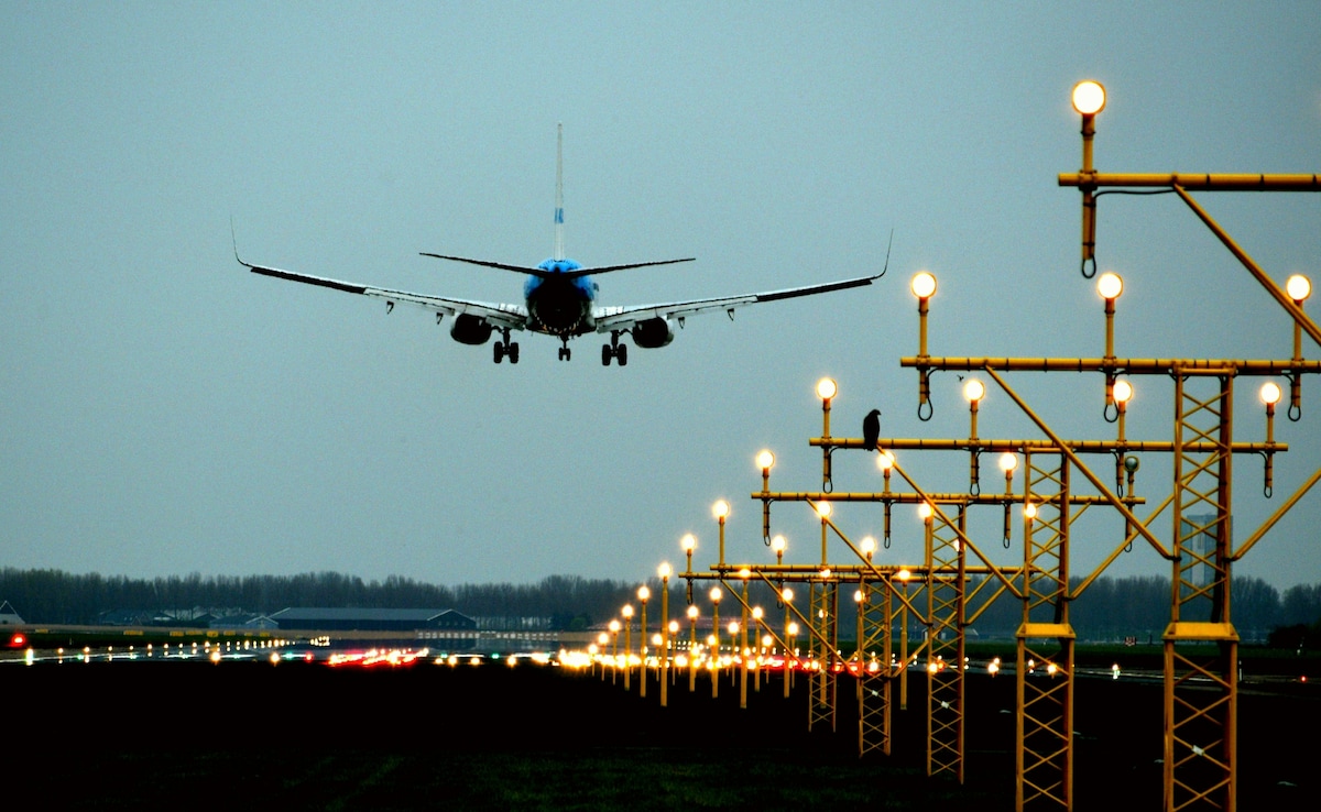 Wide-body aircraft on final approach over public viewing area