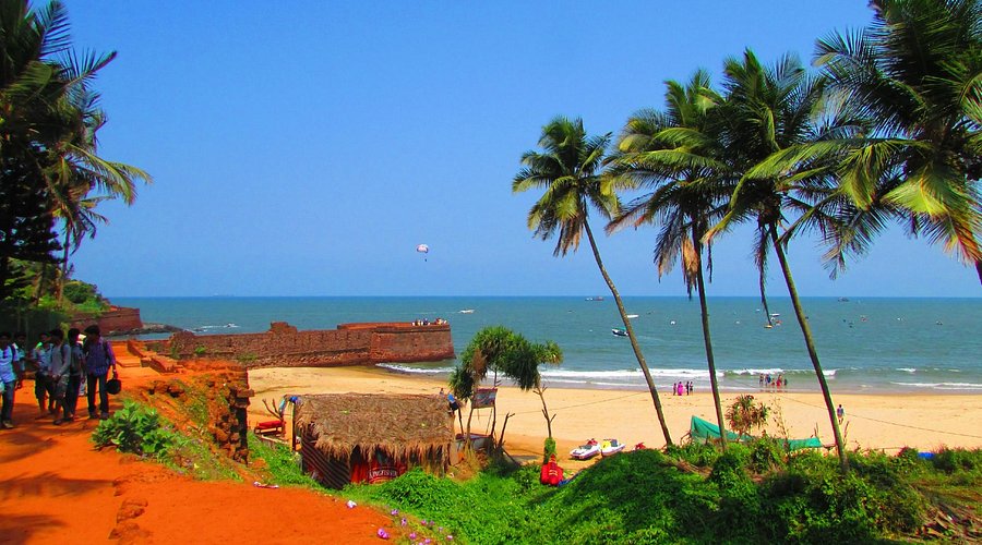 Sinquerim Beach shoreline with Fort Aguada in the background