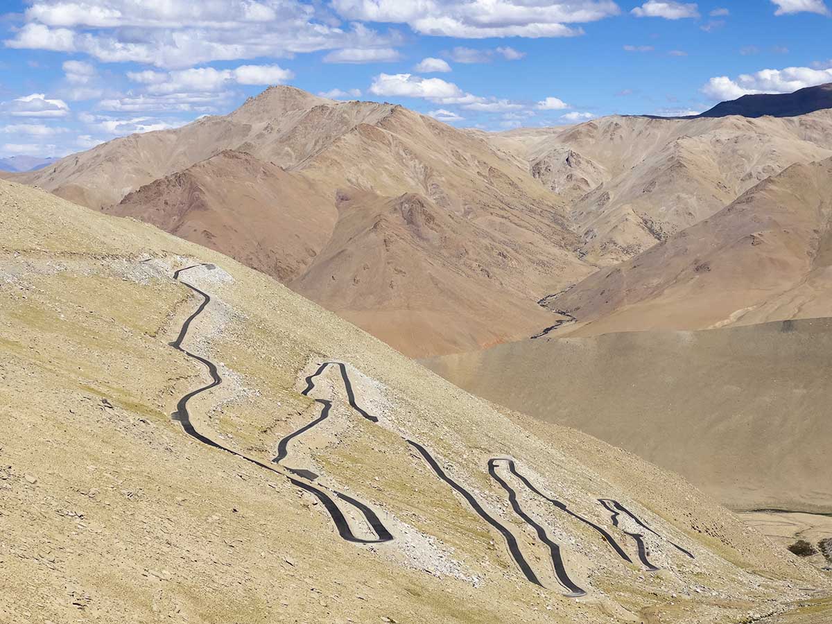 Signboard and mountain panorama at Umling La Pass Ladakh