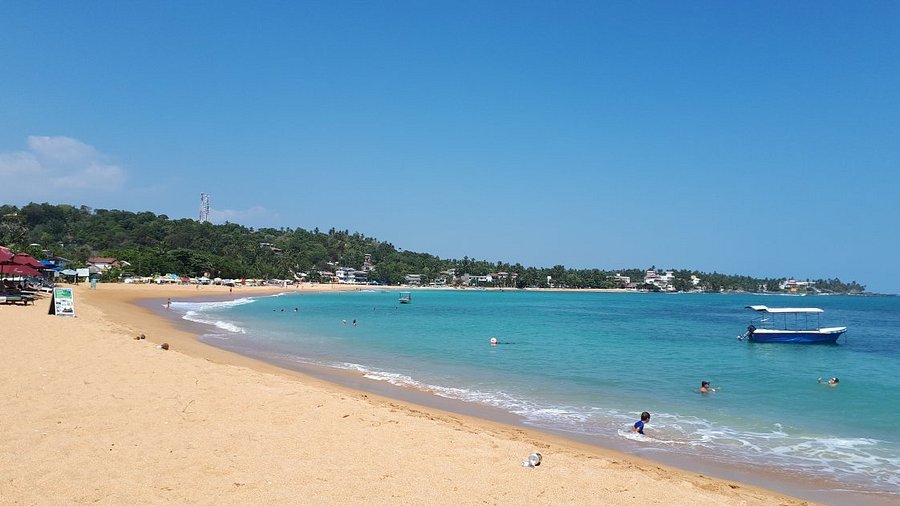 Golden sand and calm turquoise water at Unawatuna Beach Sri Lanka