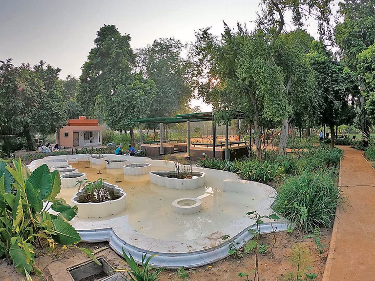 Central lawn and tree-lined walking area at Victoria Garden Ahmedabad