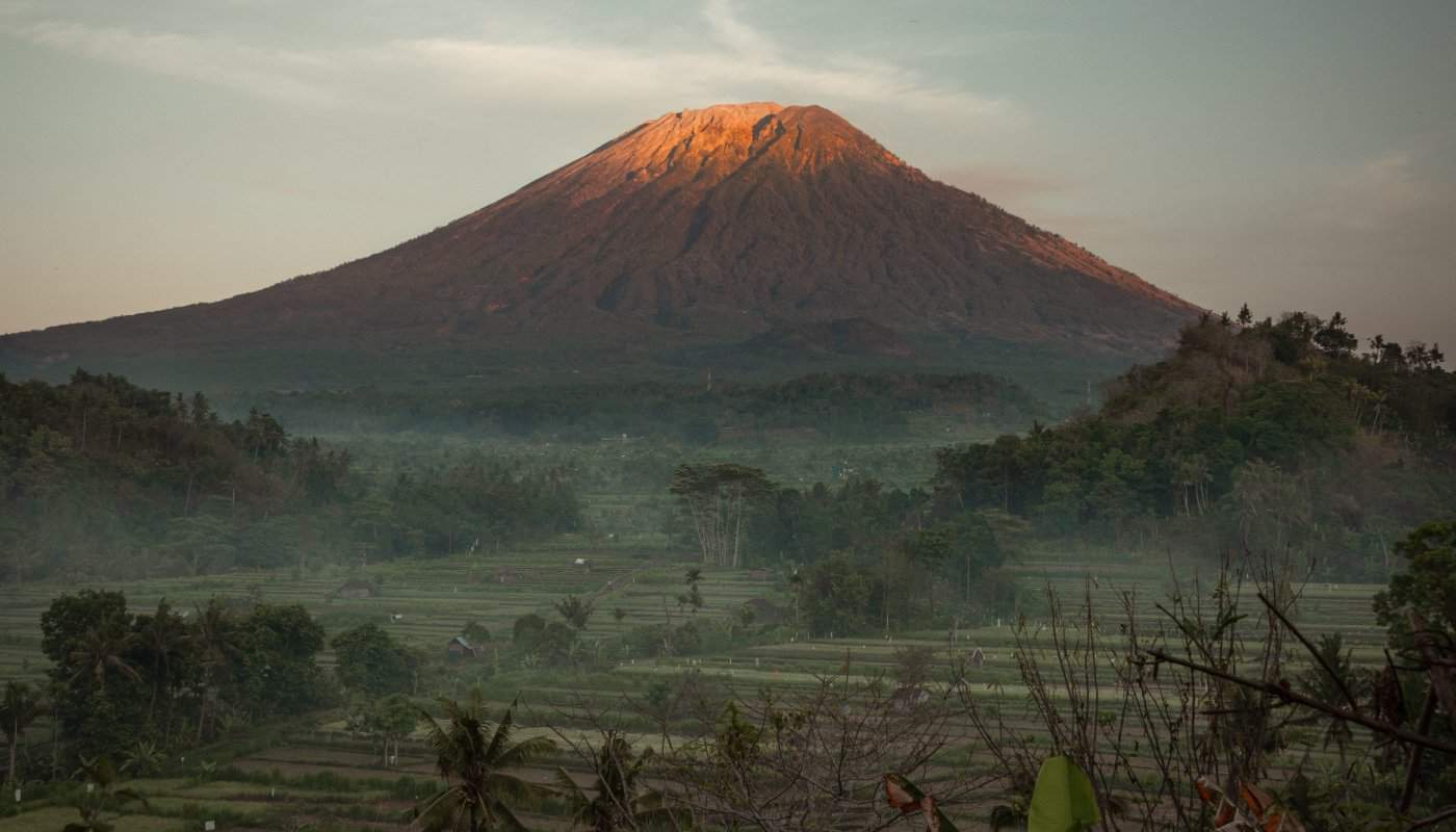 Volcanic mountain landscape in Bali with clouds and green valleys