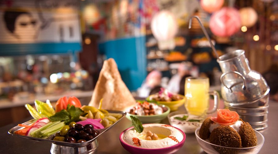 Open charcoal grill station preparing meats at Zaroob Dubai