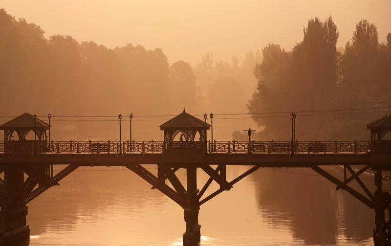 Zero Bridge Srinagar at sunset with golden light reflecting on Jhelum River